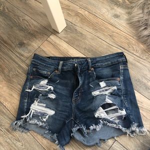 Ripped dark blue shorts.